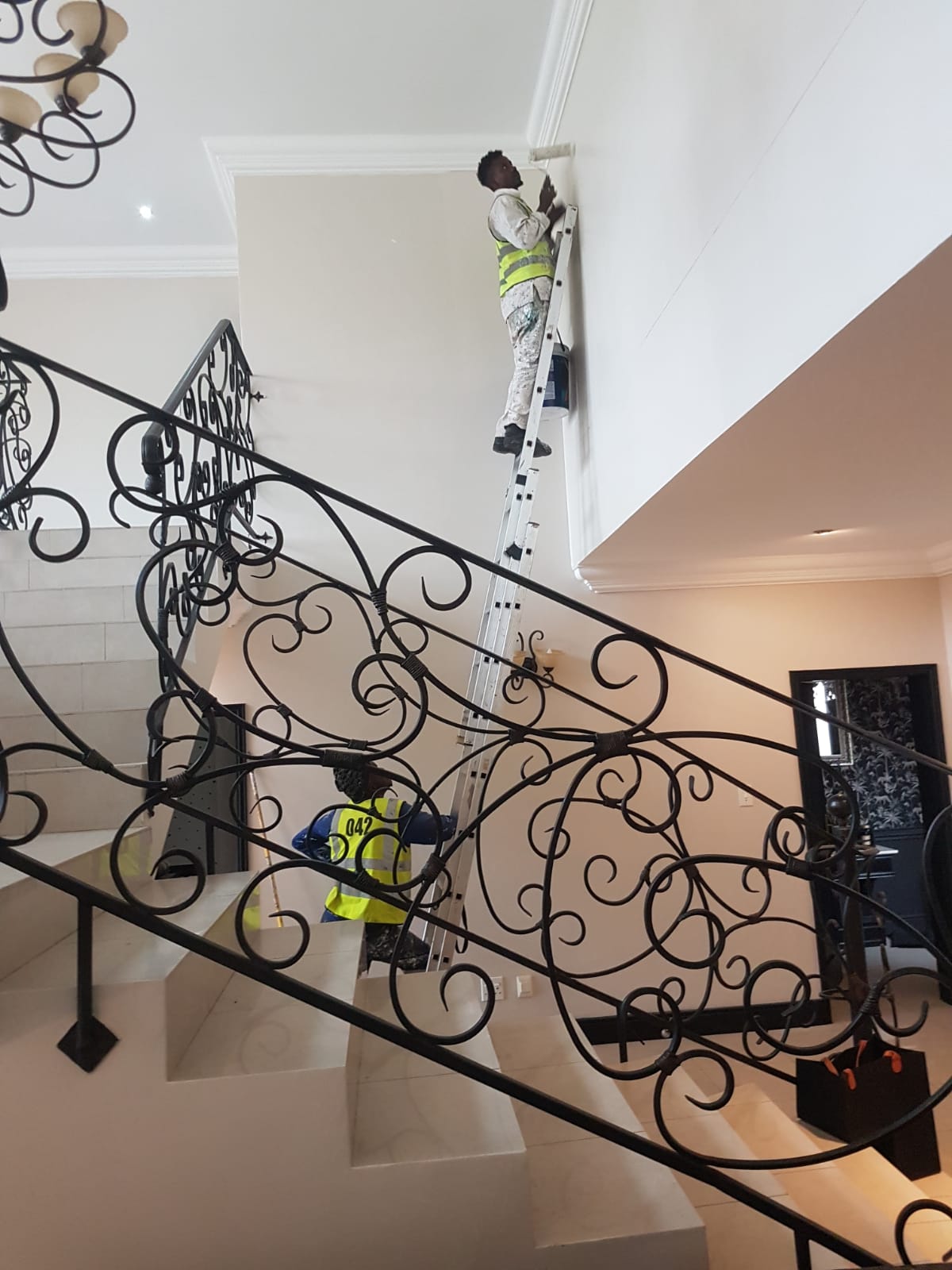 Interior painting around a decorative staircase